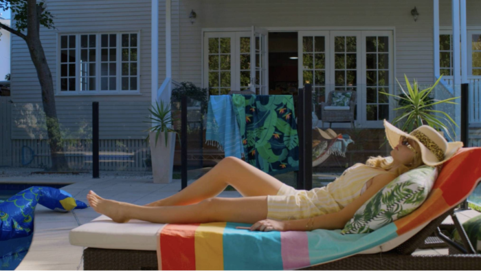 Swimming For Gold is Australia’s first feature film to be colour graded in 4K Dolbyvision.  Angela Cerasi colour graded the feature film on site at Serve Chilled, Brisbane. This shot features a woman reclining on a colourful beach chair.
