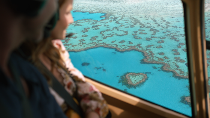Peachy Keen Colourist Angela Cerasi's colour grade of a couple looking out the window at a brilliant blue and green ocean reef, for the Tourism Queensland commercial campaign "Days Like This"