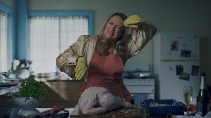 Angela Cerasi graded this shot of a woman wiping her brow with dish-gloved hands, a raw turkey on the bench in front of her, for the feature drama/ comedy film "A Savage Christmas'