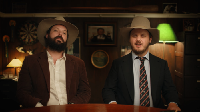 Angela Cerasi's colour grade of the Betoota Advocate editors Clancy Overell and Errol Parker (real names Archer Hamilton and Charles Single), sitting at a table in their finest Australian garb, for the Paramount+ TV series "The Betoota Advocate Presents"