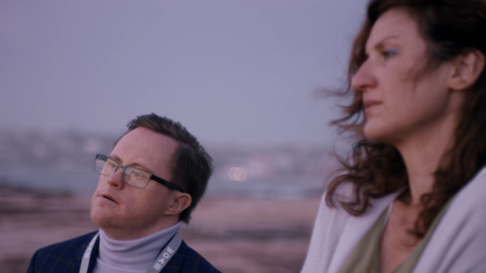 Angela Cerasi's colour grade of the characters Rose and Marty standing on a sea side cliff at dawn, from "Way Out Assistance"